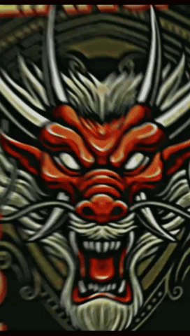 A Close Up Of A Dragon 'S Head With Horns And A Beard GIF