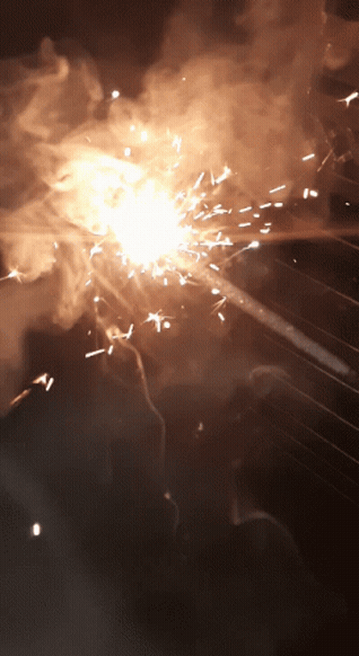 A Close Up Of A Fireworks Display With Sparks And Smoke Coming Out Of It GIF