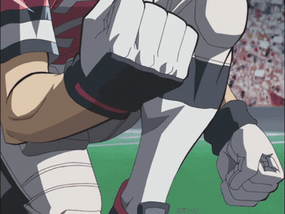 A Close Up Of A Football Player 'S Fist With A Crowd In The Background GIF