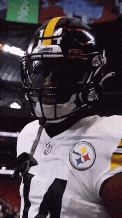 A Close Up Of A Football Player Wearing A Helmet That Says Steelers On It GIF