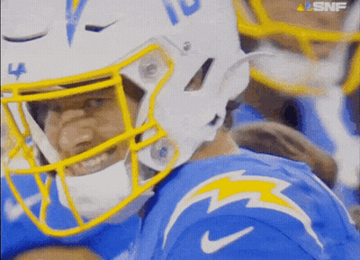 A Close Up Of A Football Player Wearing A Helmet With The Number 10 On It GIF