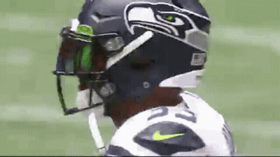 A Close Up Of A Football Player Wearing A Seahawks Helmet And Visor . GIF