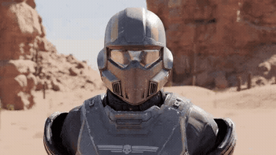 A Close Up Of A Futuristic Soldier Wearing A Helmet And Goggles In A Desert . GIF