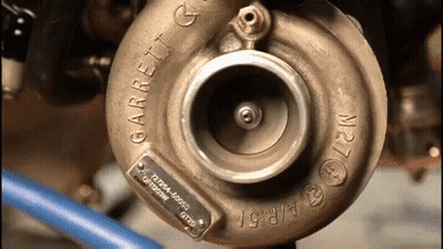 A Close Up Of A Garrett Turbocharger On A Vehicle GIF