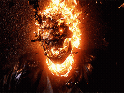 A Close Up Of A Ghost Rider With Flames Coming Out Of His Face GIF