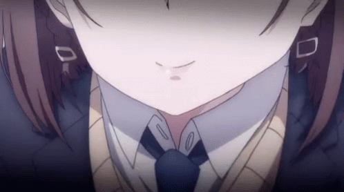 A Close Up Of A Girl 'S Face Wearing A Tie And Sweater . GIF
