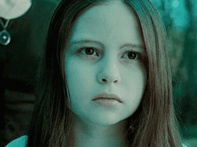 A Close Up Of A Girl 'S Face With A Blue Background GIF