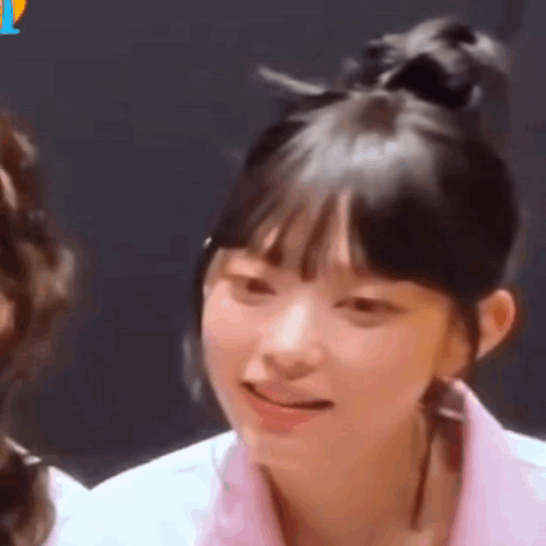 A Close Up Of A Girl 'S Face With A Bun On Her Head . GIF