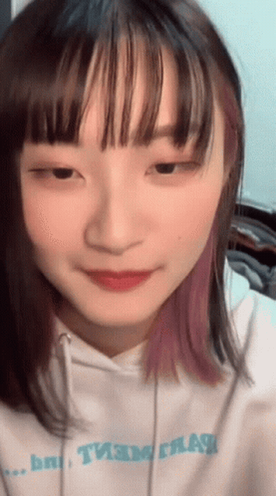 A Close Up Of A Girl 'S Face With A Hoodie That Says " Team " GIF