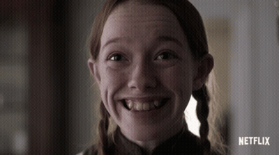 A Close Up Of A Girl 'S Face With A Netflix Logo Behind Her GIF