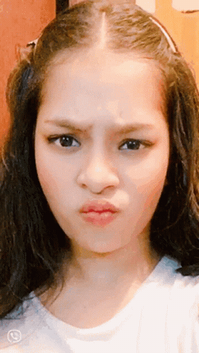A Close Up Of A Girl 'S Face With A Phone Number On The Bottom Left GIF
