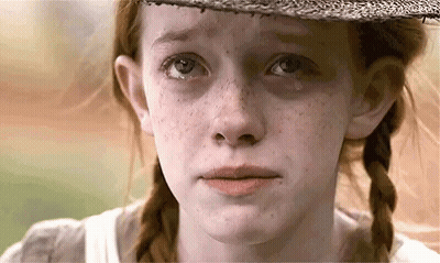 A Close Up Of A Girl 'S Face With A Tear Running Down Her Cheek . GIF