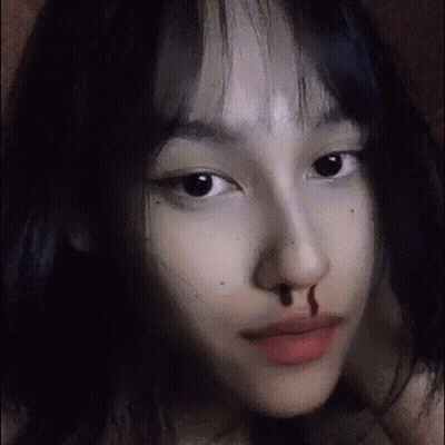 A Close Up Of A Girl 'S Face With Blood On Her Nose . GIF