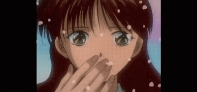 A Close Up Of A Girl 'S Face With Petals Falling On It GIF