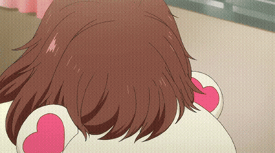 A Close Up Of A Girl 'S Hair With A Pink Heart On Her Ear GIF