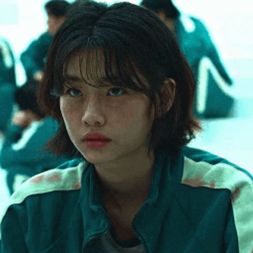 A Close Up Of A Girl Wearing A Green Jacket . GIF
