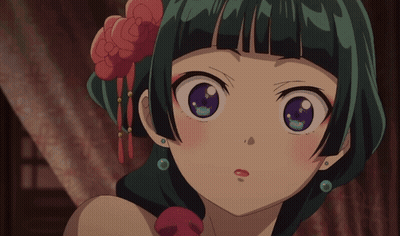 A Close Up Of A Girl With Green Hair And Purple Eyes GIF
