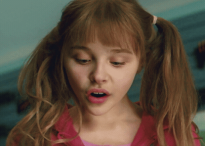 A Close Up Of A Girl With Pigtails And A Pink Shirt GIF