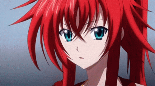 A Close Up Of A Girl With Red Hair And Blue Eyes GIF