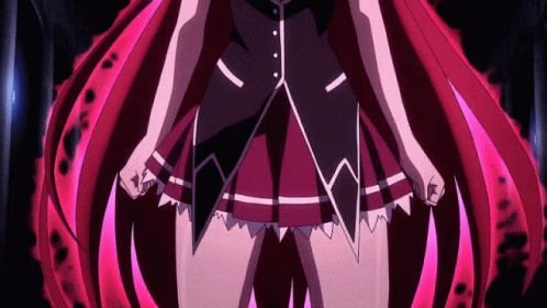 A Close Up Of A Girl With Red Hair In A Dark Room GIF