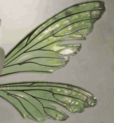 A Close Up Of A Glass Of Green Liquid With Ice Cubes In It . GIF
