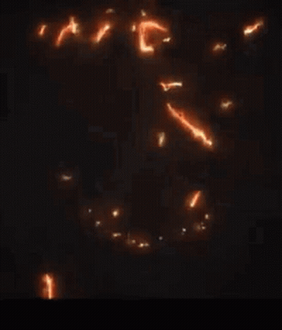 A Close Up Of A Glowing Dragon On A Black Background GIF