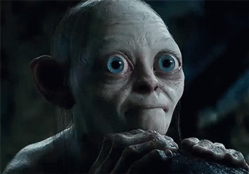 A Close Up Of A Gollum From The Lord Of The Rings With Big Blue Eyes And A Beard . GIF