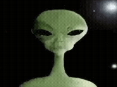 A Close Up Of A Green Alien With Black Eyes And A Long Neck . GIF