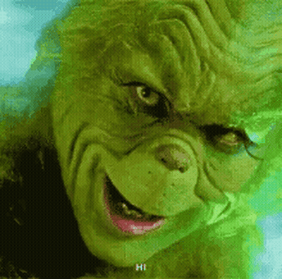 A Close Up Of A Grinch 'S Face With A Smile . GIF