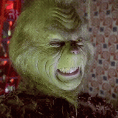 A Close Up Of A Grinch 'S Face With A Very Angry Expression . GIF