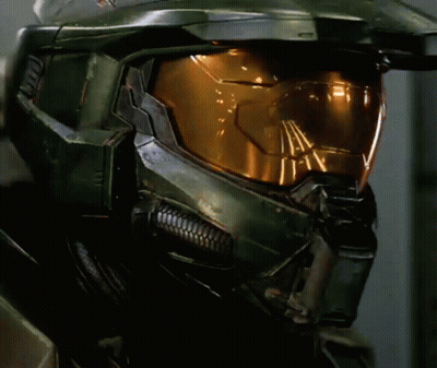 A Close Up Of A Halo Helmet With A Yellow Glowing Lens GIF