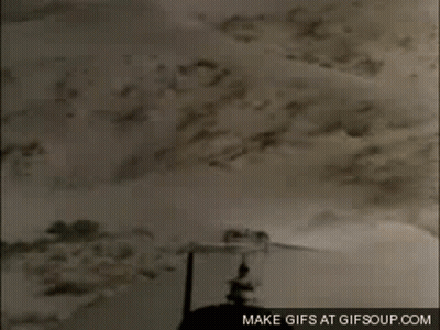 A Close Up Of A Helicopter Flying Over A Desert With The Words Make Gifs At Gifsoup.com On The Bottom GIF