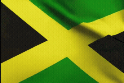 A Close Up Of A Jamaica Flag Waving In The Wind GIF