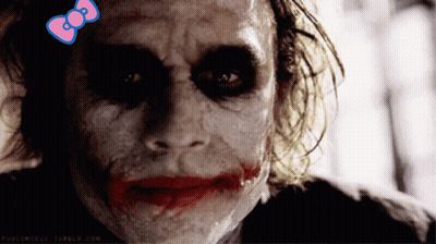 A Close Up Of A Joker With A Pink Bow On His Head GIF
