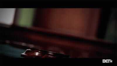 A Close Up Of A Judge 'S Gavel With A Bet Logo Below It GIF