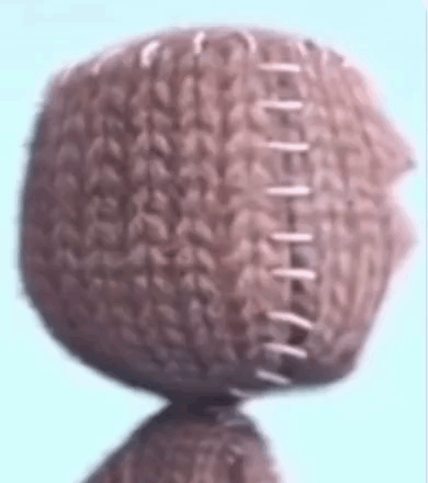 A Close Up Of A Knitted Ball With Stitching On It . GIF