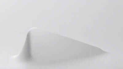 A Close Up Of A Knitted Fabric With A Geometric Pattern On It . GIF