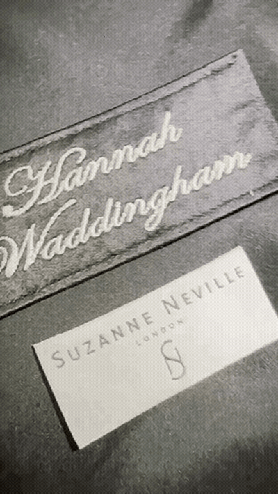 A Close Up Of A Label That Says Suzanne Neville London On It GIF