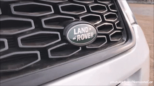 A Close Up Of A Land Rover Logo On The Grille GIF