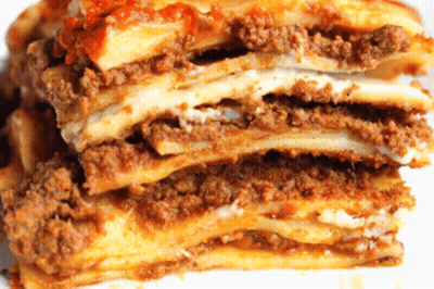 A Close Up Of A Lasagna With Meat And Cheese GIF