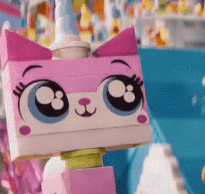A Close Up Of A Lego Cat With Big Eyes And A Unicorn Horn GIF
