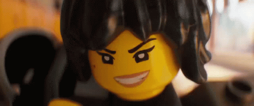 A Close Up Of A Lego Girl With A Serious Look On Her Face And A Smile On Her Face . GIF