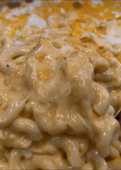 A Close Up Of A Macaroni And Cheese Casserole Dish GIF