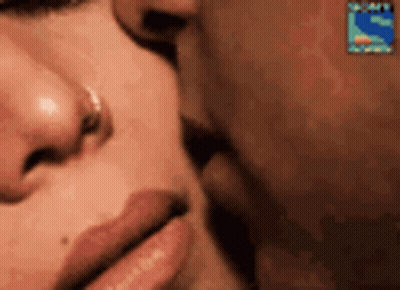 A Close Up Of A Man And A Woman Kissing . GIF