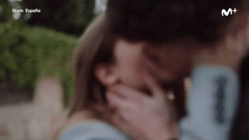A Close Up Of A Man And Woman Kissing Each Other . GIF