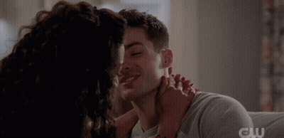 A Close Up Of A Man And Woman Kissing With The Cw Logo In The Corner GIF
