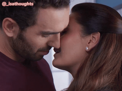 A Close Up Of A Man And Woman Kissing With The Words @Isathoughts Above Them GIF