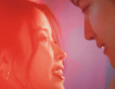 A Close Up Of A Man And Woman Kissing With Their Eyes Closed GIF
