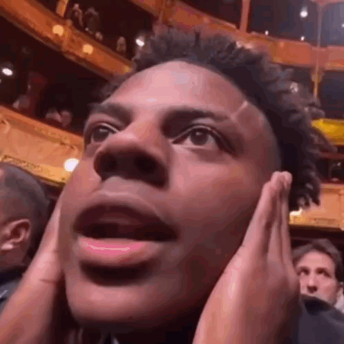 A Close Up Of A Man Covering His Ears With His Hands . GIF