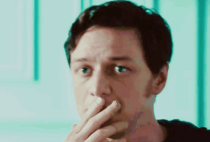 A Close Up Of A Man Covering His Mouth With His Hands GIF